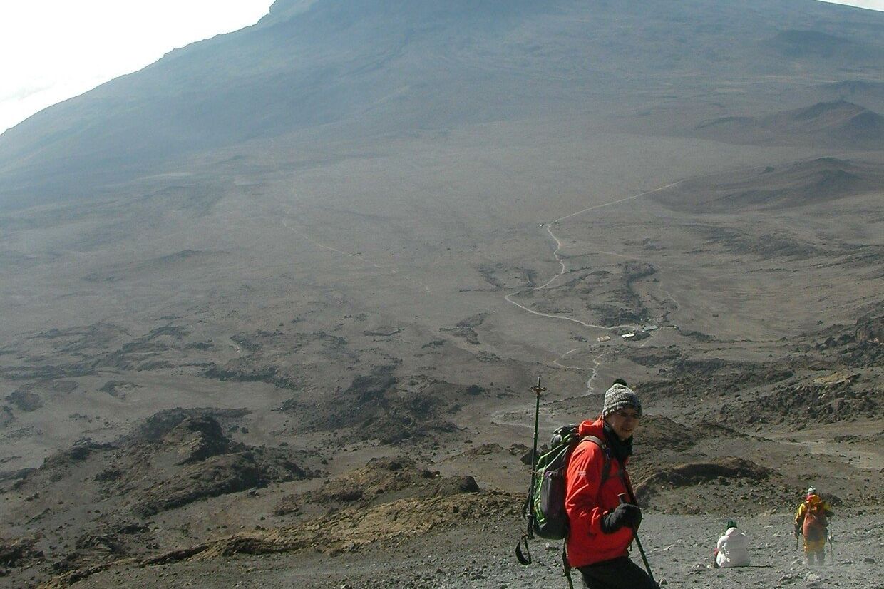 A climber in a red jacket on Kilimanjaro's upper slopes