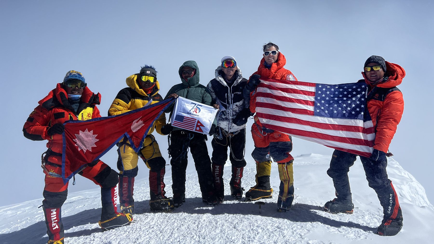 Mark Parella and the US-Nepal Friendship Team on the summit of Denali in 2023, holding the flags of Nepal and the United States